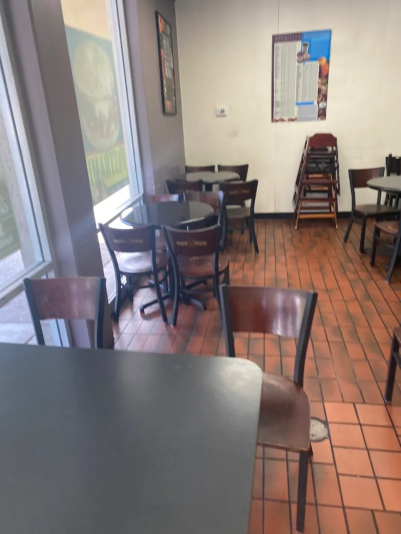 The full display case at Yum Yum Donuts showing fresh donuts of every variety